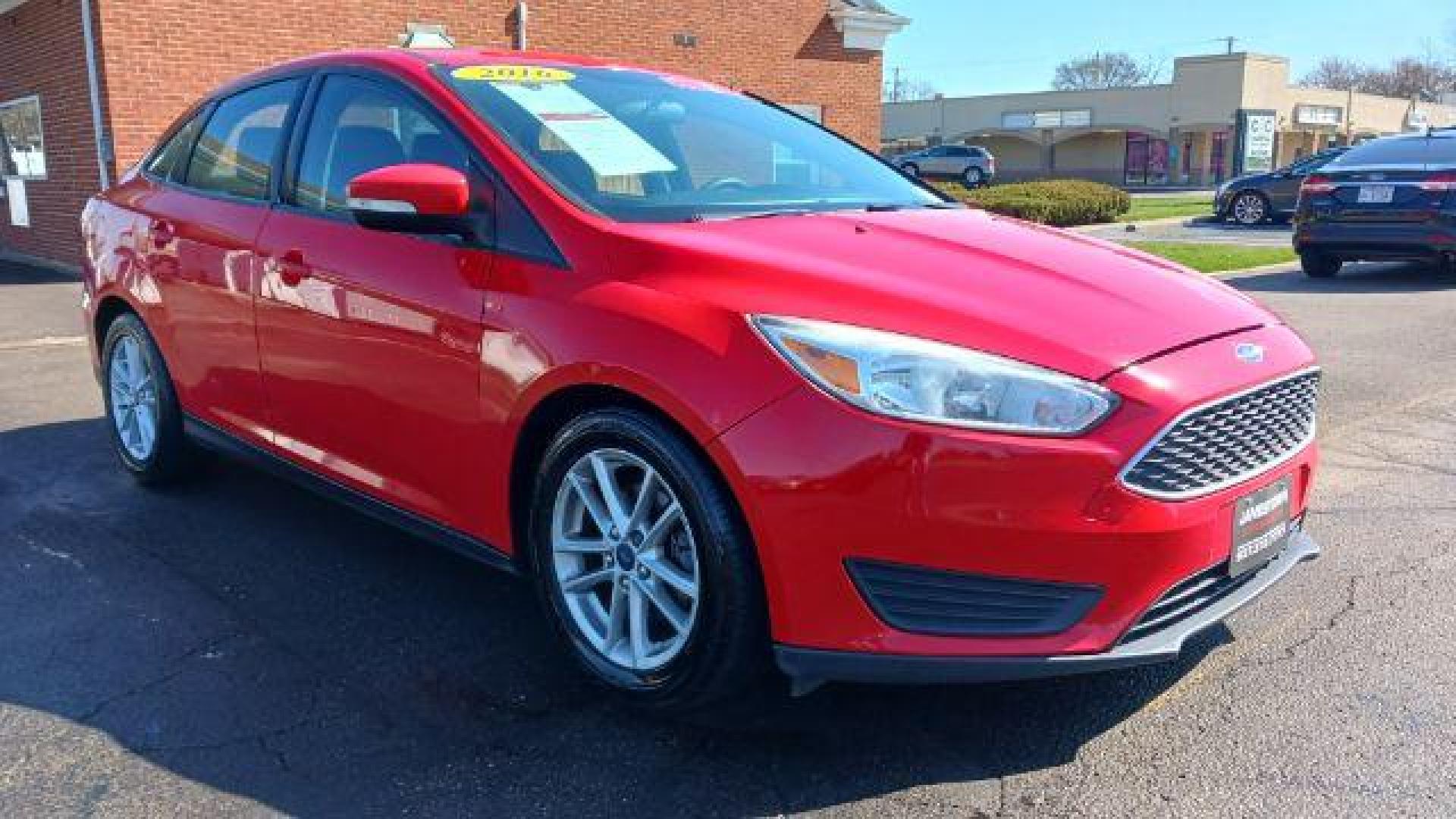 2016 Race Red Ford Focus SE Sedan (1FADP3F28GL) with an 2.0L L4 DOHC 16V engine, located at 1865 W 2nd St., Xenia, OH, 45385, (937) 372-7777, 39.681259, -83.961945 - Photo#0